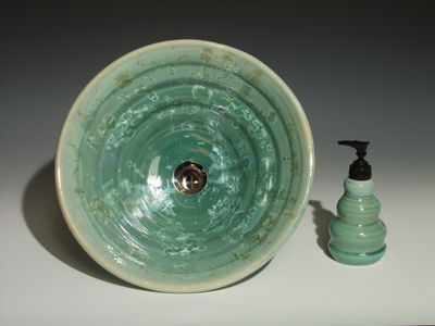 Beehive handmade sink in a turquoise copper crystal glaze
front view with matchshape soap pump