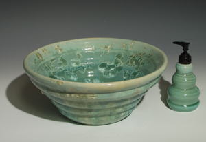 Beehive handmade sink in a turquoise copper crystal glaze
front view with matching shaped soap pump