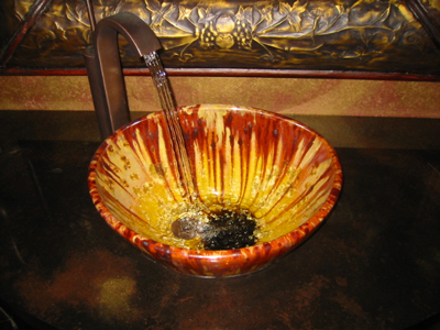 Unusual sink in an oviod form with drain off to one side shown installed.