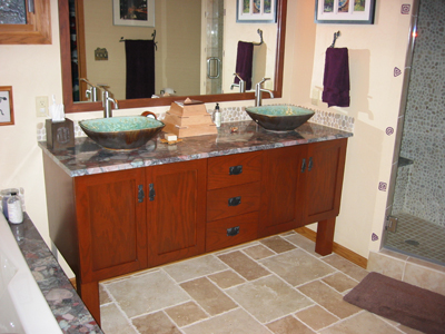 pair of rectangular artistic sinks installed, the glaze matches turquoise tones in the granite