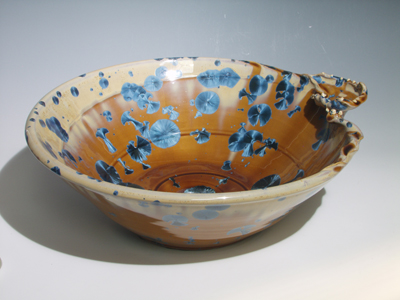 Nickle crystal amber orange with blue glaze, really cool sink with integrated soap dish, artistic with a wavy lip.